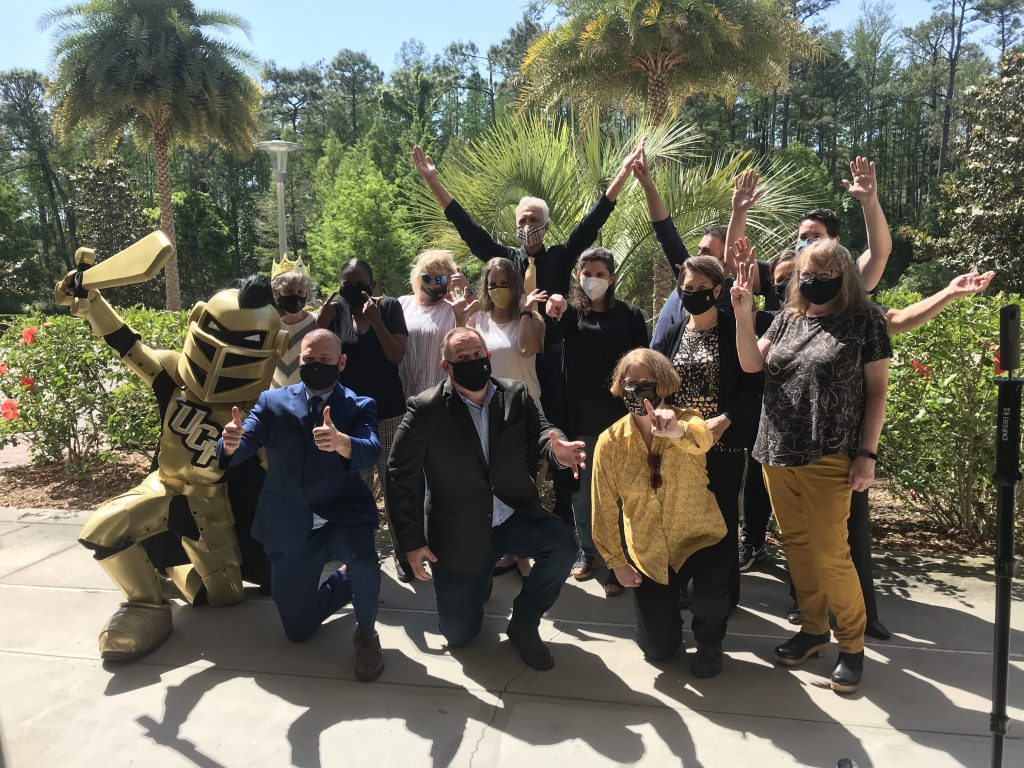 Knighted Faculty Cohort 2021 pose outside with Knightro.