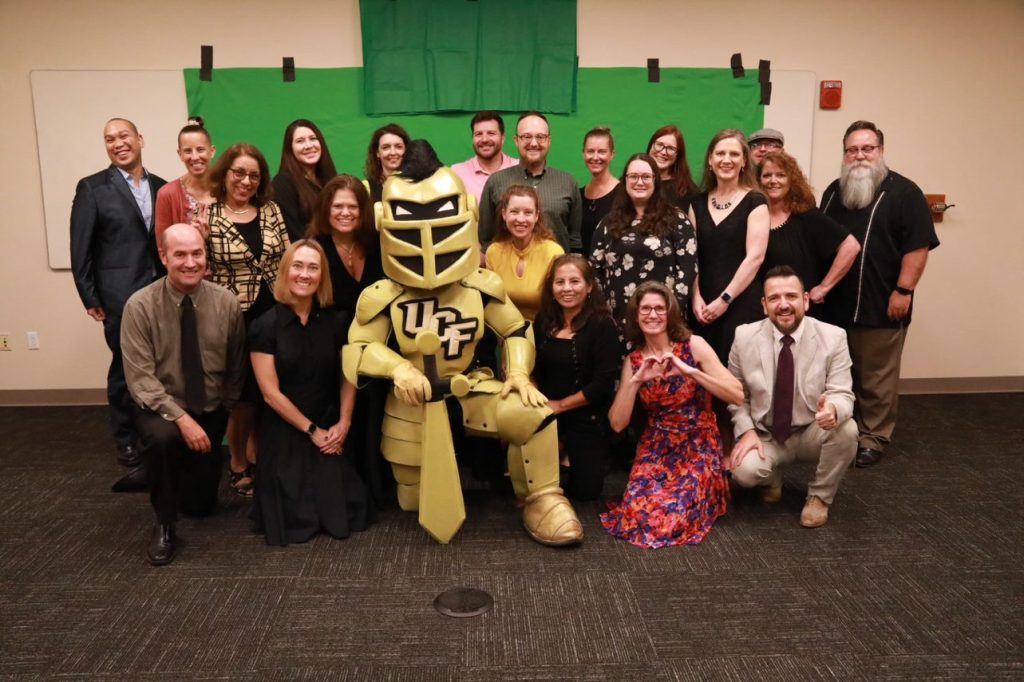 The second cohort of the Knighted Faculty Program pose with Knightro.